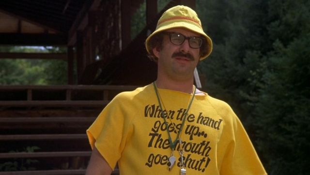 Tee shirt that says “When the hand goes up the mouth goes shut” worn by Morty (Harvey Atkin) as seen in Meatballs