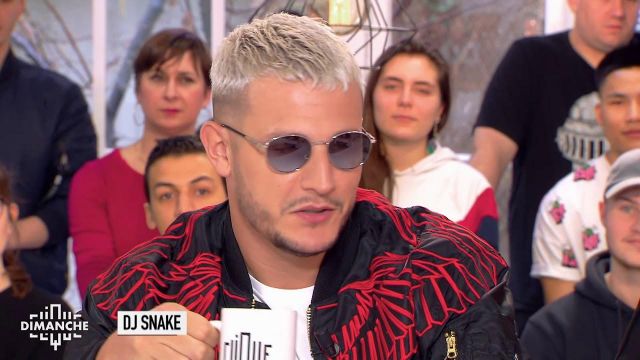 DJ Snake wears a black bomber jacket with red wings Marcelo Burlon during his appearance on Clique Sunday, February 27, 2018