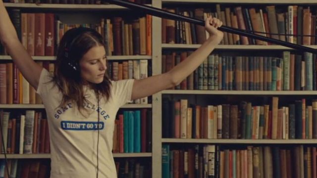 The white slogan tee "some college I didn't go to" worn by Tipper (Dree Hemingway) on While We're Young