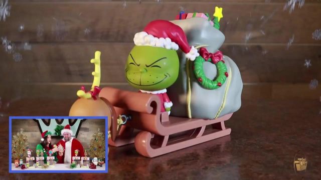 The figurine funko pop the sled for the grinch in the youtube video Dr. Seuss The Grinch Unboxing