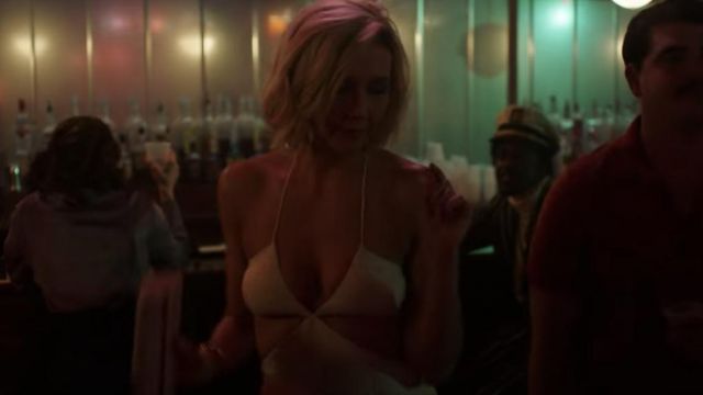 White cut-out jumpsuit worn by Candy (Maggie Gyllenhaal) as seen in The Deuce S02