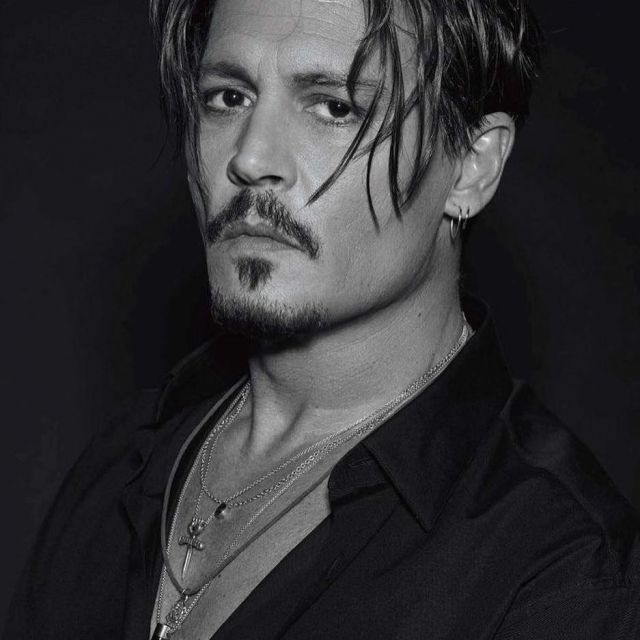 The pendant Gonzo worn by Johnny Depp on a black and white photo of a ...