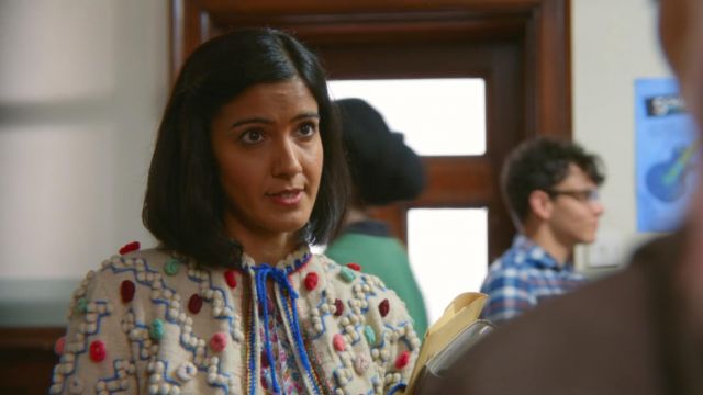 Miss Sands' (Ra­khee Tha­krar) top with wool pom poms as seen in Sex Edu­ca­tion S01E03