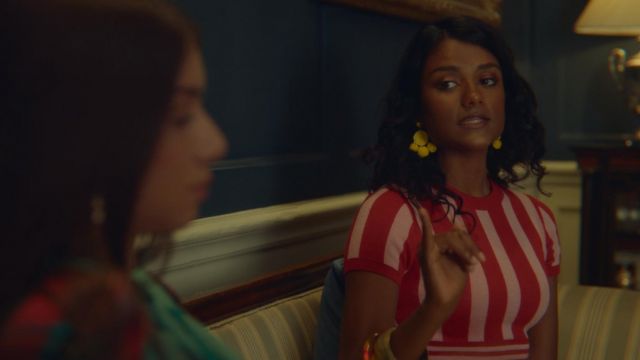Yellow pom pom earrings worn by Oli­via (Si­mone Ash­ley) as seen in Sex Edu­ca­tion TV series outfits Season 1 Episode 5