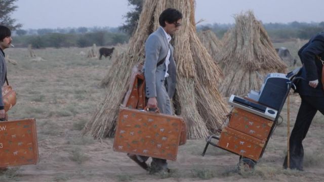 The gray suit of Adrien Brody in aboard the Darjeeling Limited