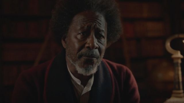 The velvet fitted jacket of Dr. Carne (Clarke Peters) in His Dark Materials (S01)