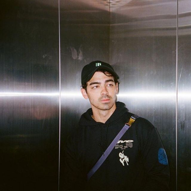 Black cap with green logo worn by Joe Jonas on his Instagram account @joejonas May 21, 2019