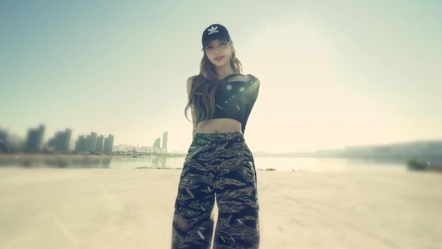 The black cap Adidas worn by Lisa of Blackpink in the video X ACADEMY TEASER VIDEO #4 of HOONY, DK, LISA X HITECH, CRAZY
