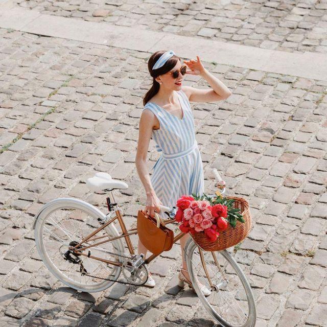 The striped dress blue and white with knot in the back worn by Daphne Moreau's Fashion blog And The City for its collection The Petticoats of Louison