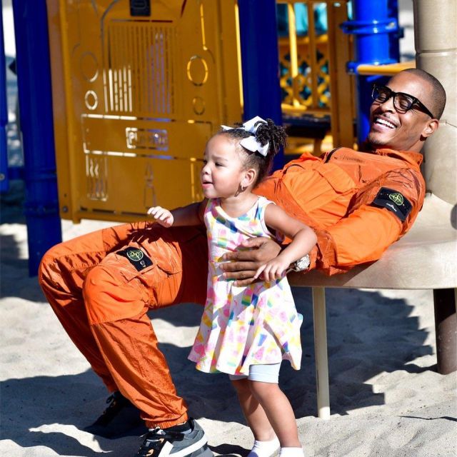 Stone island XO Bar­ney's Or­ange Hood­ed Jack­et of T.I. on the Instagram account @troubleman31