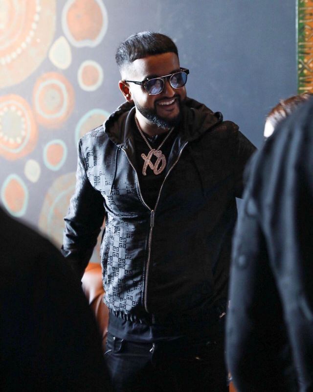 Givenchy Black Allover Lo­go Print Hood­ed Jack­et of Nav on the Instagram account @nav