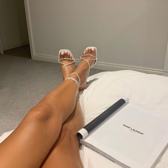 Bro­di White Heels of Charlotte Emily Sanders on the Instagram account @charlotteemilysanders