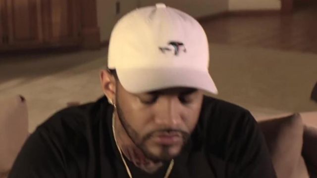 The white cap Crown of Laurel Joyner Lucas in her video clip I'm Sorry (508)-507-2209