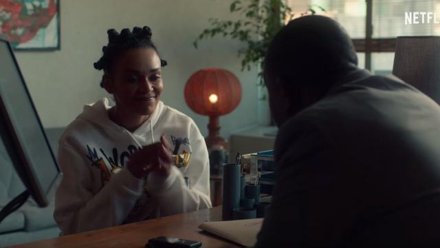 The hoody with white printed graffiti of Queen Sono (Pearl Thusi) in Queen Sono (S01)
