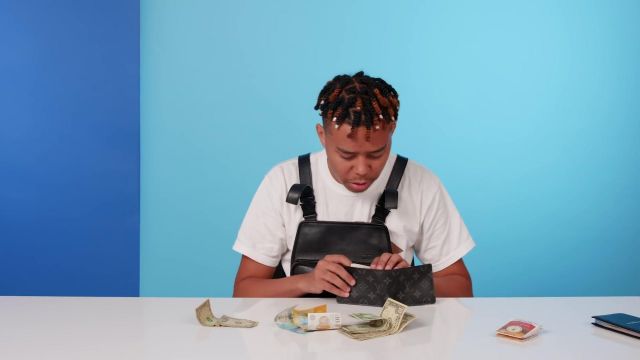 Louis Vuitton Monogram Eclipse Canvas Slender Wallets worn by YBN Cordae in 10 Things YBN Cordae Can't Live Without | GQ