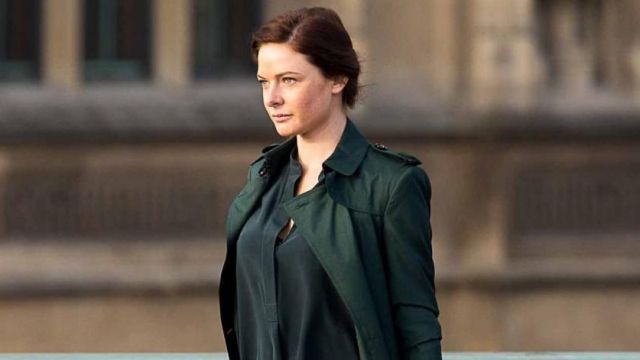 The dark green trench coat worn by Ilsa Faust (Rebecca Ferguson) in the movie Mission Impossible - Rogue Nation