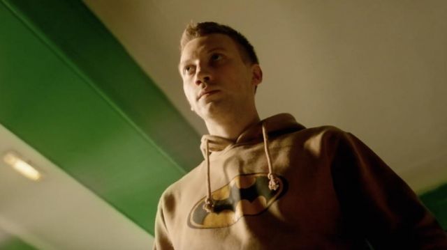 Batman logo hoodie in gold worn by Matvey (Alexander Kuznetsov) in Why Don't You Just Die!