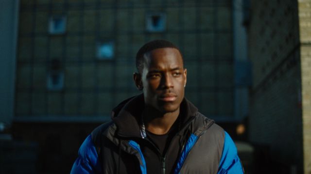The blue and black jacket The North Face worn by Dushane (Ashley Walters) in the series Top Boy (Season 2 Episode 8)