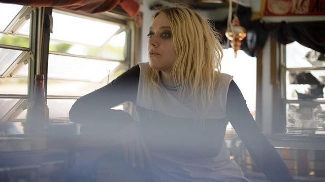 Long sleeve black and white top worn by Viena (Dakota Fanning) as seen in Viena and the Fantomes