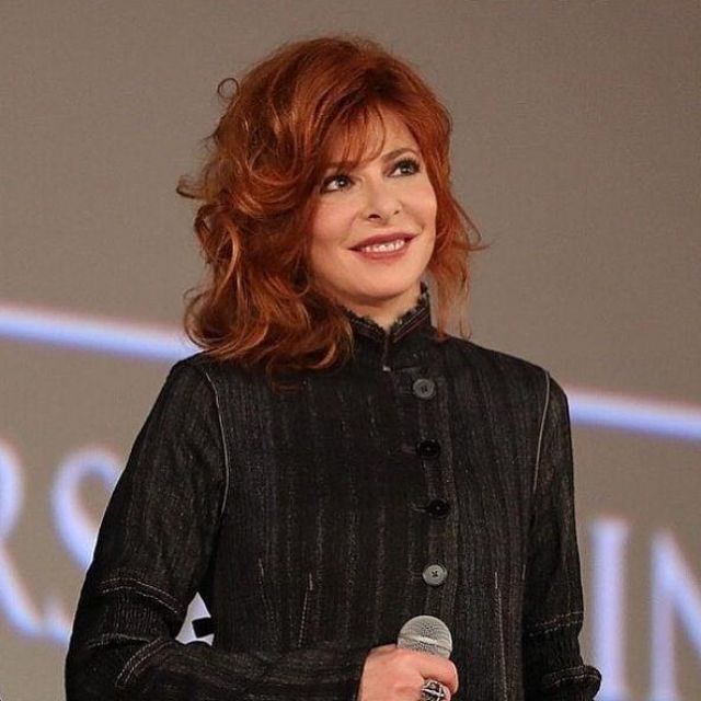 The black shirt with high collar lace worn by Mylène Farmer on the account instagram of @mylene.farmer