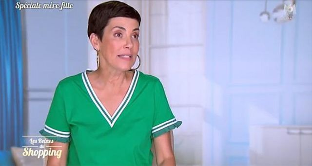 The green V-neck dress worn by Cristina Cordula in the show Les Reines du Shopping