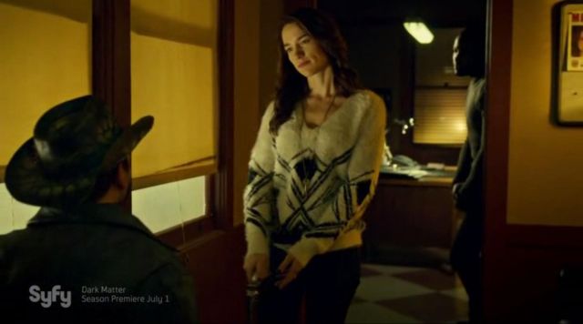 The geometrically patterned sweater worn by Wynonna Earp (Melanie Scrofano) in the series Wynonna Earp (Season 1 Episode 9)