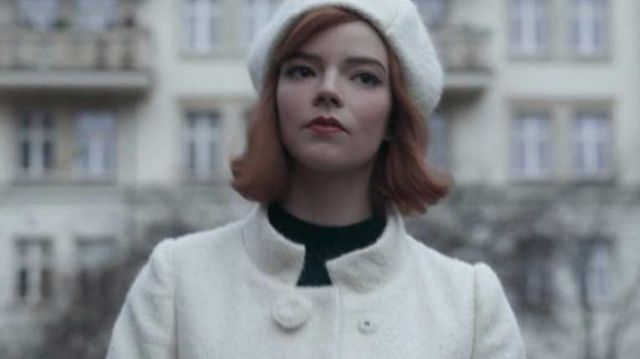Outfits of The Queen's Gambit:  Beth Harmon (Anya Taylor-Joy) wears 60s white wool coat in season 1, episode 7