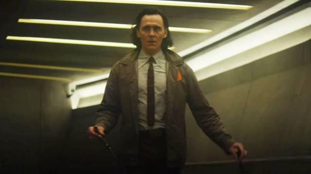 Brown Coat jacket with orange patch worn by Loki (Tom Hiddleston) in Loki TV series (Season 1 Episode 1)