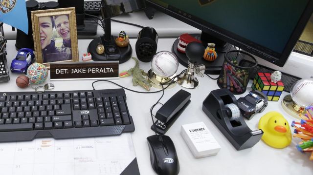 Baseball holder on the desk of Jake Peralta (Andy Samberg) in Brooklyn Nine-Nine