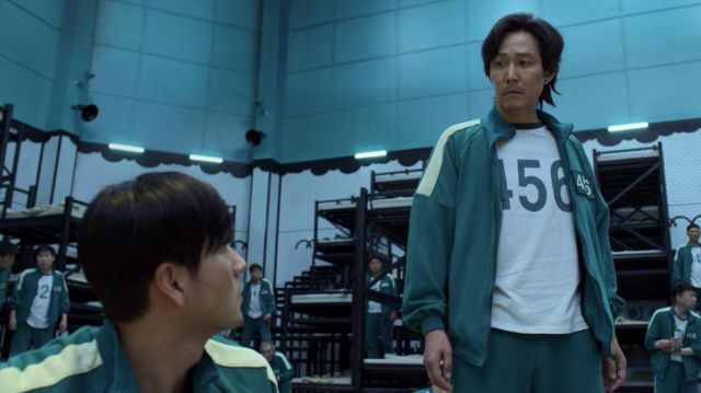 Green and white track pants and hoodie with 456 worn by Seong Gi-hun (Lee Jung-jae) as seen in Squid Game TV series wardrobe (S01E04)