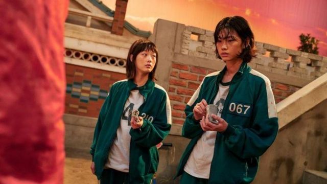 Green Tracksuit with white bands and 240 worn by Ji Yeong (Lee Yoo-mi) as seen in Squid Game Outfits (S01E06)