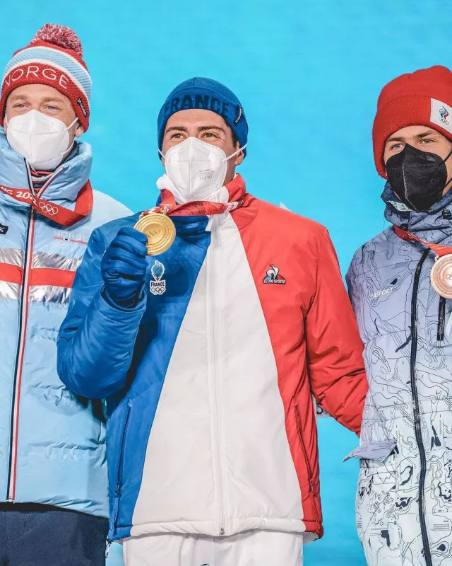The Olympic down jacket blue white red Le Coq Sportif worn by Quentin Fillon Maillet on his account Instagram @quentinfillon