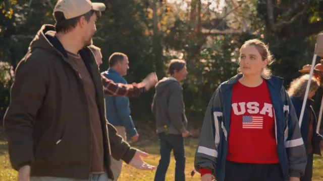 USA Flag Long-sleeved Shirt in Red worn by Kelly (Chelsea Holmes) in Welcome to Flatch (S01E01)