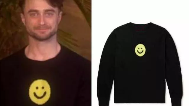 Yellow Happy Smiley Face  long sleeve sweatshirt in black worn by Daniel Radcliffe in Access Hollywood TV show on March 21, 2022