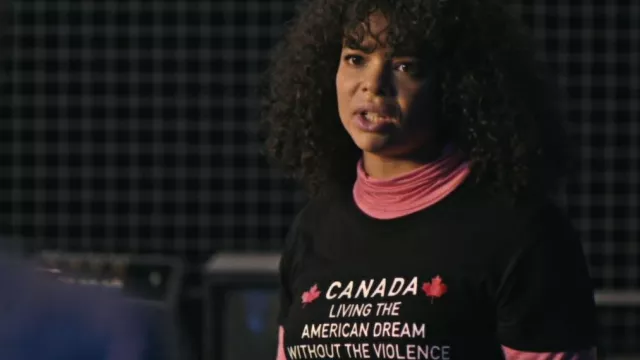 Canada Living The American Dream Without The Violence Since 1867 T-Shirt worn by Reilly Clayton (Lydia West) in The Pentaverate (Season 1 Episode 1)
