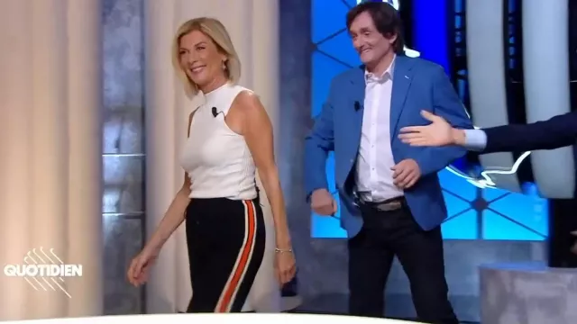 Black pants with white and orange stripes worn by Michèle Laroque in Quotidien on April 18, 2022