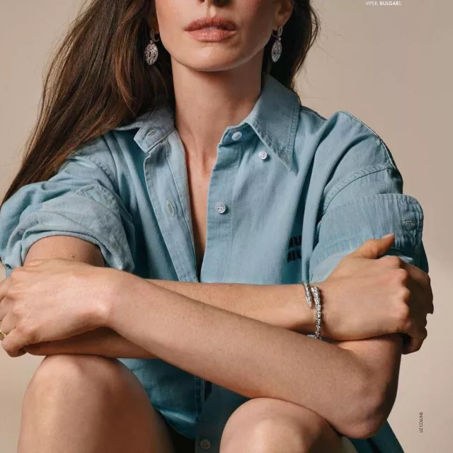 The Miu Miu denim shirt worn by Anne Hathaway 
during Liz Collins' photoshoot for Elle France Magazine on June 23, 2022
