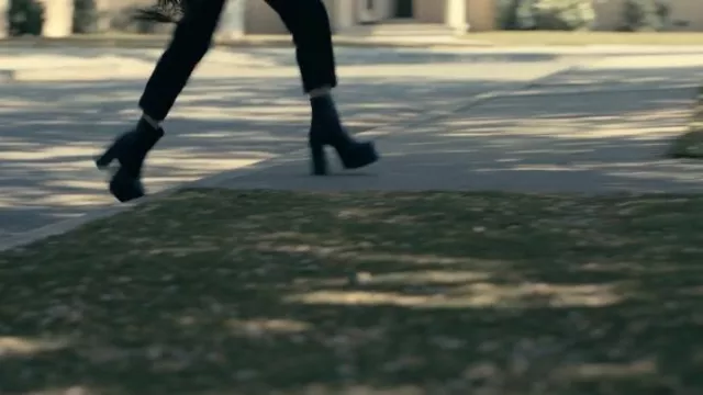 The black platform boots worn by Cassie (Sofia Carson) in Our Bruised Hearts