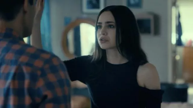 La Made black one off shoulder top worn by Cassie (Sofia Carson) as seen in Purple Hearts movie outfits