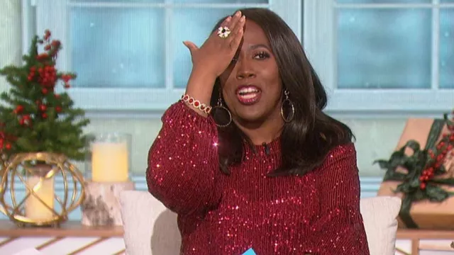 Cece Long Sleeve Cold Shoulder Round Neck Sequin Blouse worn by Sheryl Underwood as seen in The Talk on December 14, 2022