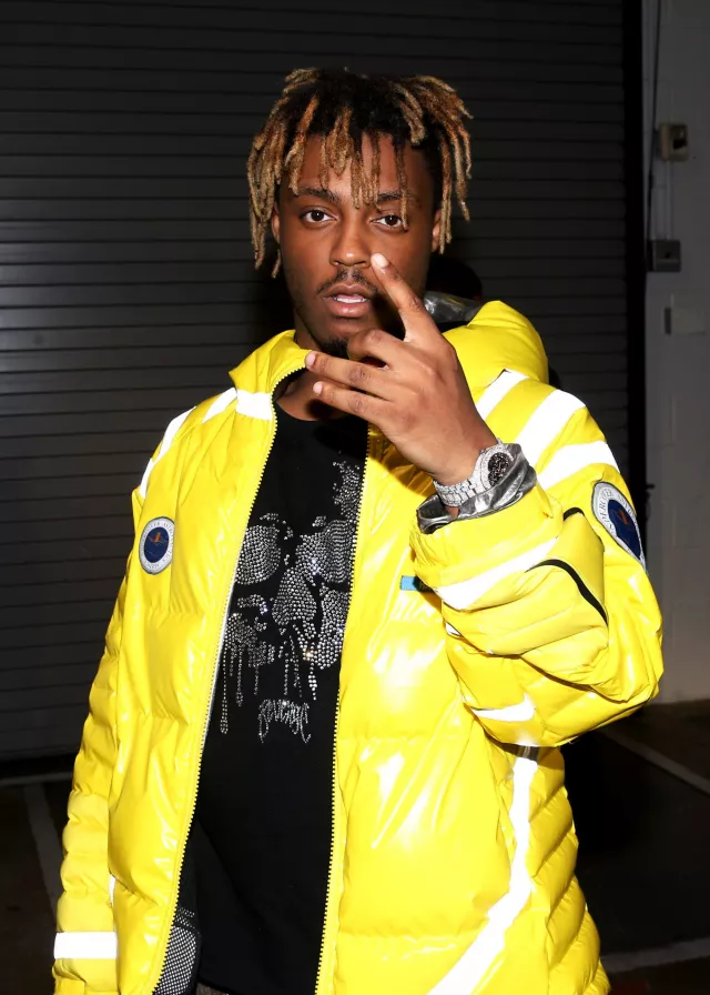 Undercover 2001: Space Odyssey hooded yellow down jacket worn by Juice Wrld attending the 2018 Power 105.1's Powerhouse NYC at Prudential Center on October 28, 2018 in Newark, New Jersey
