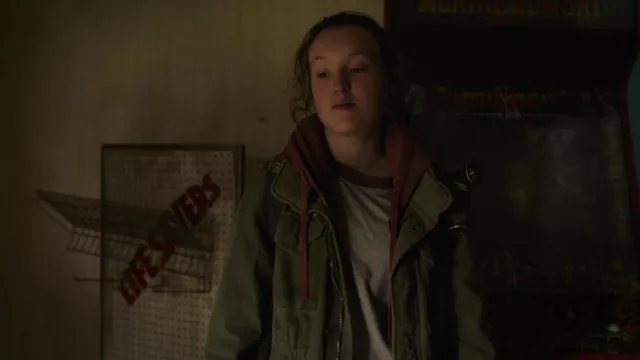 Olive green zip parka jacket worn by Ellie Williams (Bella Ramsey) as seen in The Last of Us TV series (Season 1 Episode 3)