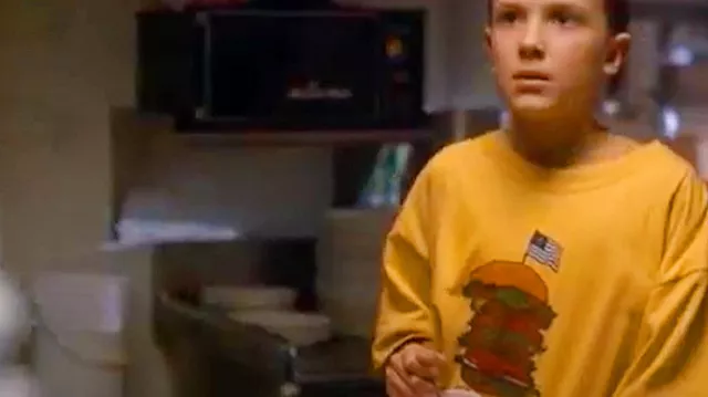 Yellow Benny's Burger T-Shirt worn by Eleven (Millie Bobby Brown) in Stranger Things (Season 1 Episode 1)
