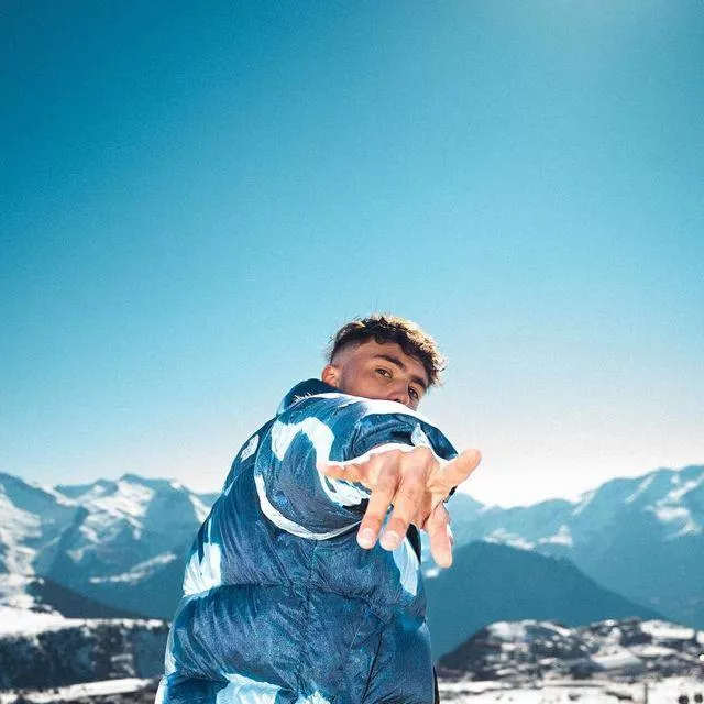 The blue and white down jacket with faded effect Supreme x The North Face worn by Inoxtag on his Instagram account @inoxtag