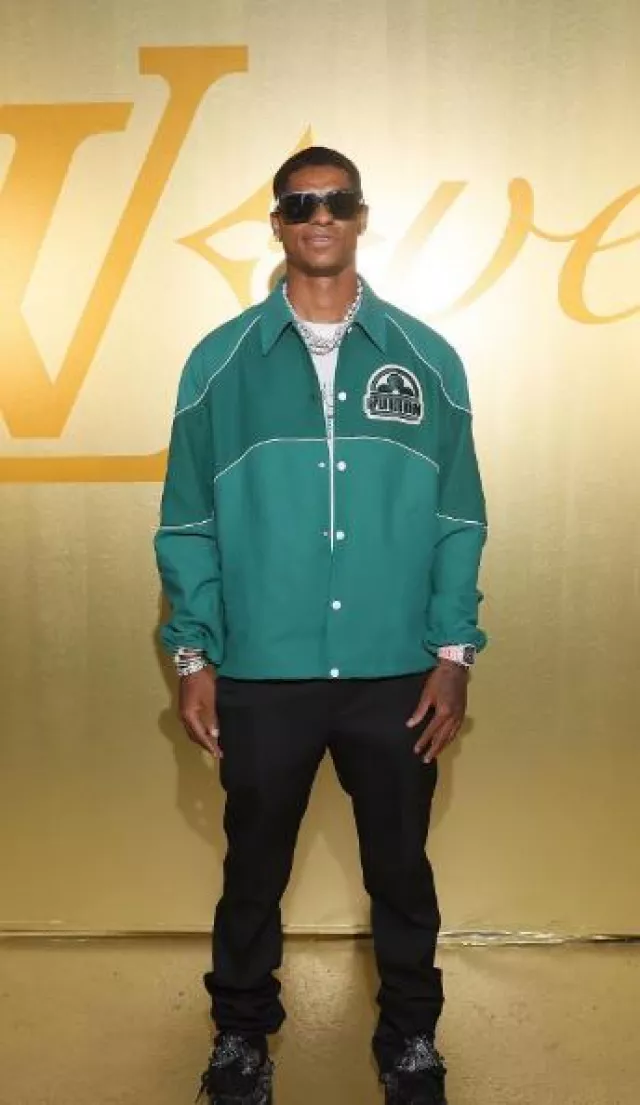 Louis Vuitton Green Logo Coaches Jacket worn by Marcus Rashford attending Louis Vuitton Menswear Spring/Summer 2024 show
