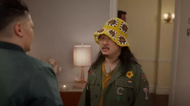 Tory Burch Cro­chet-Knit Buck­et Hat worn by Jackie Nee (Bobby Lee) as seen in And Just Like That… (S02E11)