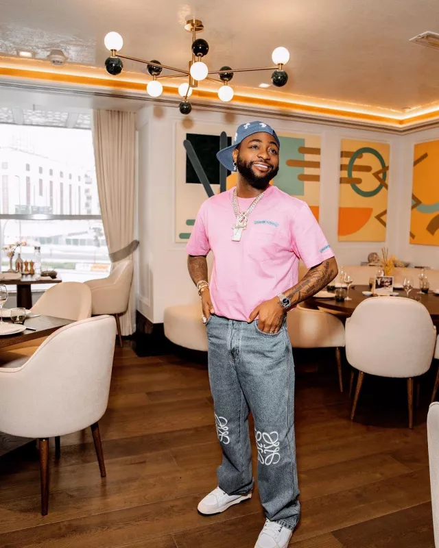 Chrome Hearts Pink & Neon Blue Scroll Lo­go T-Shirt worn by Davido on his Instagram account @davido