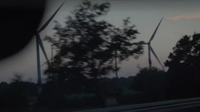 Wind turbine builder in Hamburg, Germany driven past by Maria (Kim Basinger) in I Am Here