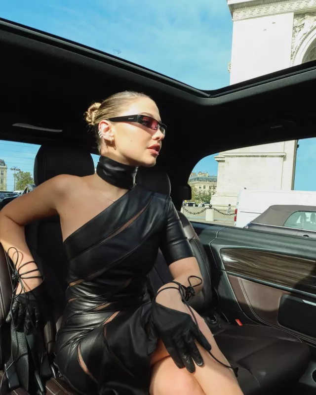 Givenchy Asymmetrical Dress with Leather Bands worn by Madelyn Cline at Givenchy Show on September 28, 2023