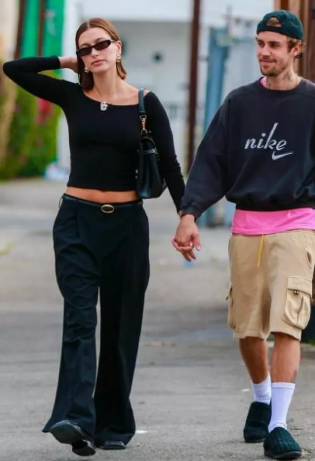 Dries Van Noten Black Pleated Trousers worn by Hailey Bieber in Los Angeles on October 10, 2023